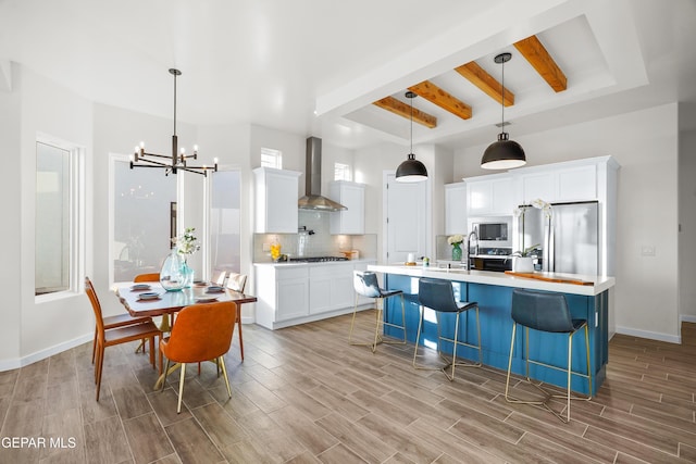 3829 Aspire Pl, El Paso, TX 79938 - kitchen with wall chimney exhaust hood, freestanding refrigerator, beam ceiling, built in microwave, and light countertops