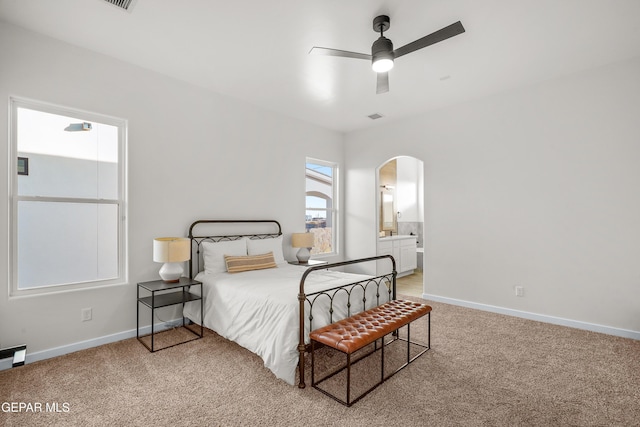 3829 Aspire Pl, El Paso, TX 79938 - bedroom featuring arched walkways, light colored carpet, baseboards, and connected bathroom