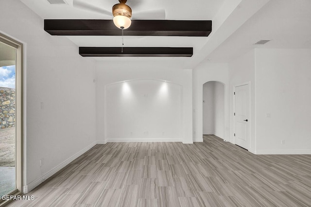 3825 Aspire Pl, El Paso, TX 79938 - unfurnished room featuring beam ceiling, light wood-style floors, arched walkways, baseboards, and ceiling fan