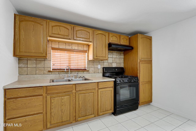 7701 Hermosillo Dr, El Paso, TX 79915 - kitchen with black gas range, a sink, under cabinet range hood, decorative backsplash, and light countertops