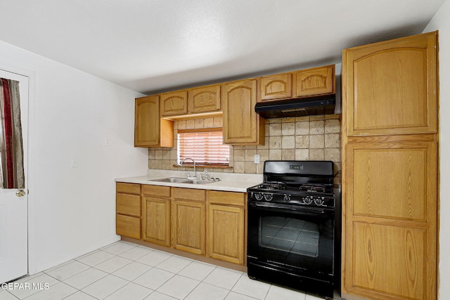 7701 Hermosillo Dr, El Paso, TX 79915 - kitchen featuring gas stove, under cabinet range hood, a sink, tasteful backsplash, and light countertops