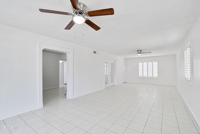 7701 Hermosillo Dr, El Paso, TX 79915 - spare room with ceiling fan, a textured ceiling, and light tile patterned floors