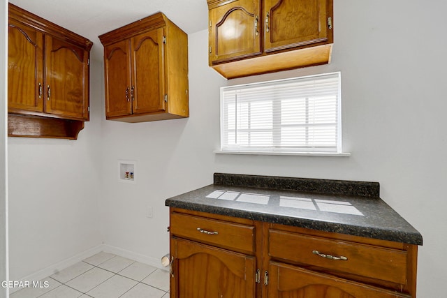 7701 Hermosillo Dr, El Paso, TX 79915 - laundry room with washer hookup, cabinet space, light tile patterned floors, and baseboards