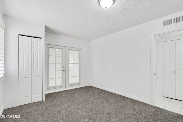 7701 Hermosillo Dr, El Paso, TX 79915 - unfurnished bedroom featuring carpet floors, a textured ceiling, and baseboards