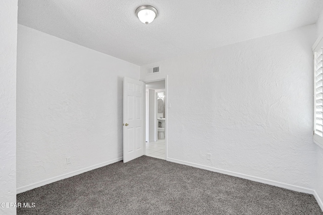 7701 Hermosillo Dr, El Paso, TX 79915 - carpeted spare room featuring a textured ceiling, a textured wall, and baseboards