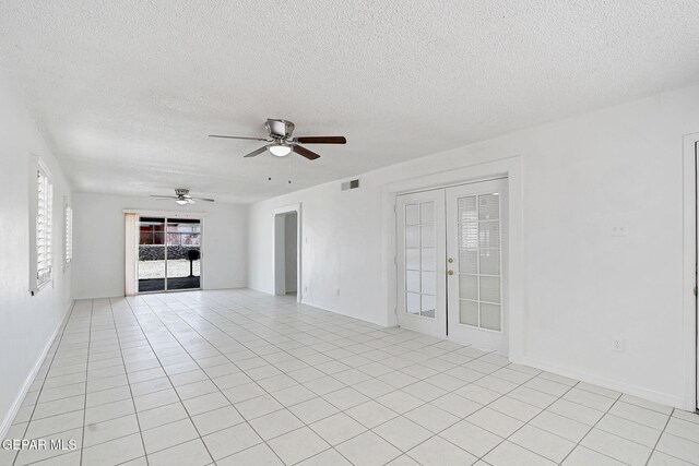 7701 Hermosillo Dr, El Paso, TX 79915 - empty room featuring a textured ceiling, ceiling fan, light tile patterned floors, and baseboards