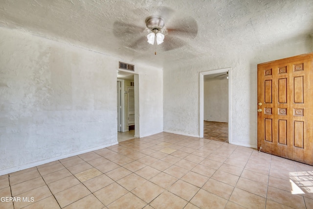 159 Silvas Way, El Paso, TX 79907 - spare room with ceiling fan, light tile patterned flooring, a textured ceiling, and a textured wall