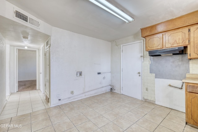 159 Silvas Way, El Paso, TX 79907 - kitchen with light tile patterned floors, under cabinet range hood, light countertops, and backsplash