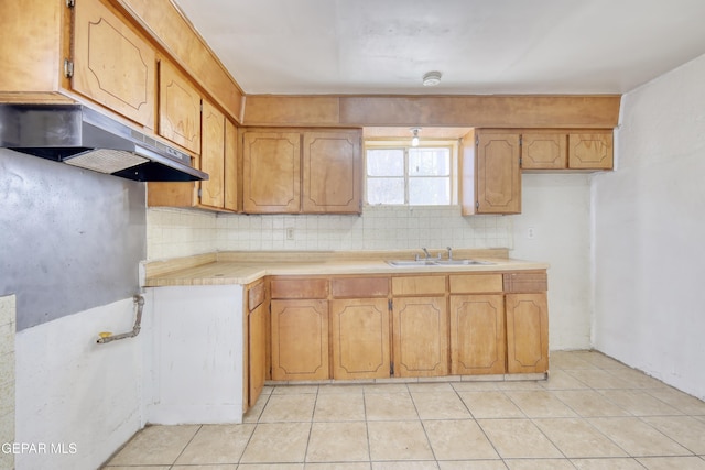 159 Silvas Way, El Paso, TX 79907 - kitchen with under cabinet range hood, backsplash, light countertops, light tile patterned floors, and brown cabinets