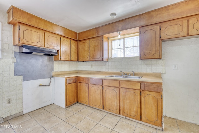 159 Silvas Way, El Paso, TX 79907 - kitchen with under cabinet range hood, tasteful backsplash, light tile patterned floors, and light countertops