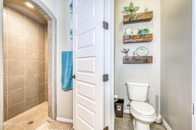 13729 Blackburn Ave, El Paso, TX 79928 - bathroom featuring baseboards, tiled shower, toilet, and tile patterned floors