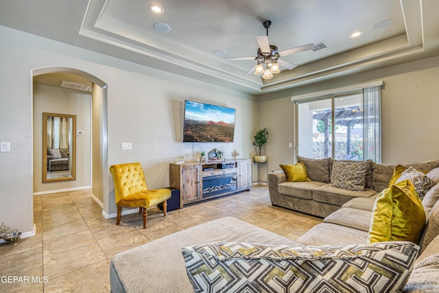13729 Blackburn Ave, El Paso, TX 79928 - living area featuring a tray ceiling, arched walkways, ceiling fan, recessed lighting, and baseboards
