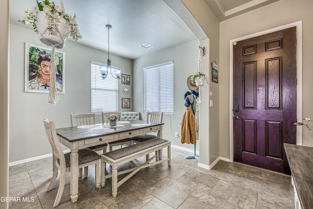 13729 Blackburn Ave, El Paso, TX 79928 - dining room featuring arched walkways, baseboards, and a chandelier