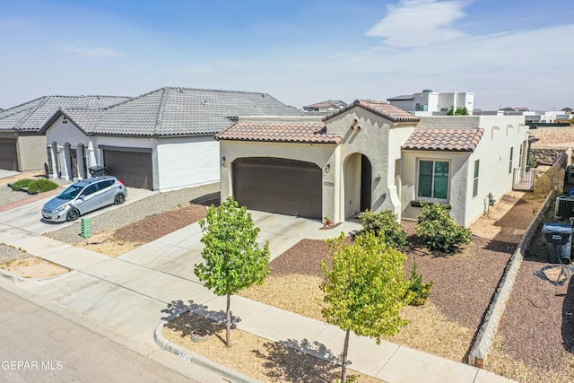 13729 Blackburn Ave, El Paso, TX 79928 - mediterranean / spanish-style house featuring stucco siding, a garage, a tiled roof, and driveway