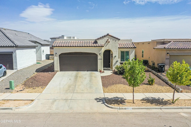 13729 Blackburn Ave, El Paso, TX 79928 - mediterranean / spanish home featuring a garage, a tile roof, stucco siding, concrete driveway, and cooling unit