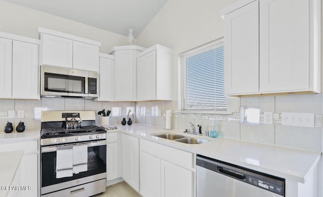 556 Cedarwood Ave, El Paso, TX 79928 - kitchen featuring appliances with stainless steel finishes, a sink, backsplash, and white cabinetry