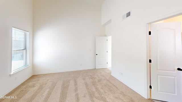 556 Cedarwood Ave, El Paso, TX 79928 - carpeted empty room featuring a towering ceiling and baseboards