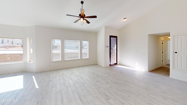 556 Cedarwood Ave, El Paso, TX 79928 - unfurnished living room featuring plenty of natural light, a ceiling fan, light wood-type flooring, vaulted ceiling, and baseboards