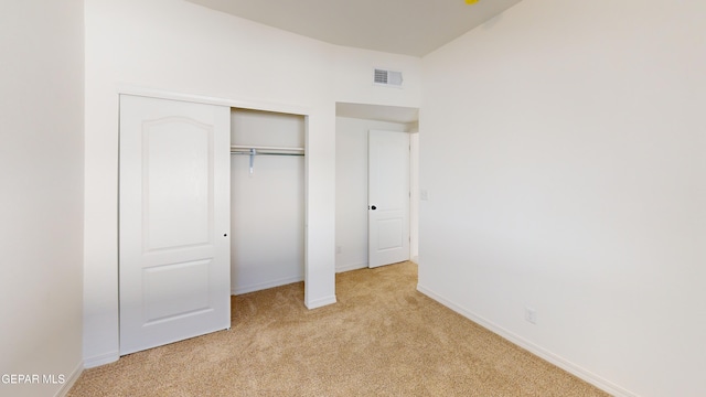 556 Cedarwood Ave, El Paso, TX 79928 - unfurnished bedroom with light colored carpet, baseboards, and a closet