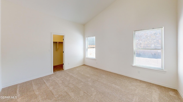 556 Cedarwood Ave, El Paso, TX 79928 - spare room featuring carpet, high vaulted ceiling, and baseboards