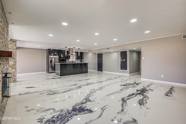 1957 Ratner Cir, El Paso, TX 79936 - unfurnished living room with recessed lighting, light marble finish flooring, baseboards, and a fireplace