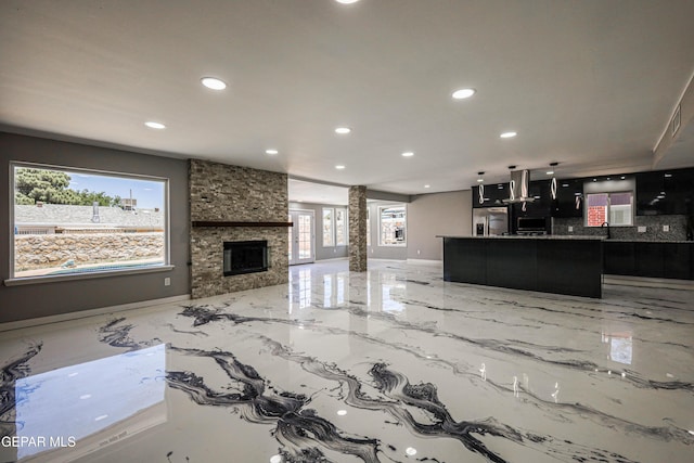 1957 Ratner Cir, El Paso, TX 79936 - living room with recessed lighting, light marble finish flooring, a fireplace, baseboards, and ornate columns