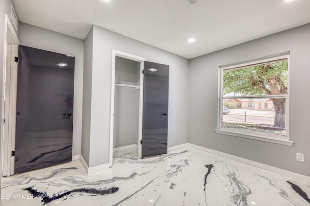 1957 Ratner Cir, El Paso, TX 79936 - unfurnished bedroom featuring marble tiled floors, baseboards, recessed lighting, and a closet