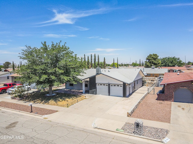 1957 Ratner Cir, El Paso, TX 79936 - view of front of property featuring an attached garage, concrete driveway, and a residential view