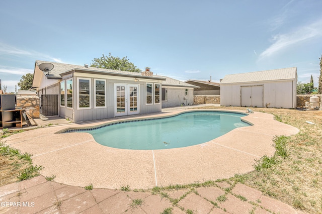 1957 Ratner Cir, El Paso, TX 79936 - view of pool featuring french doors, an outbuilding, a patio area, a shed, and fence