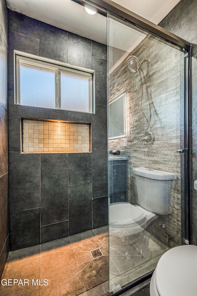 1957 Ratner Cir, El Paso, TX 79936 - bathroom featuring toilet and a tile shower