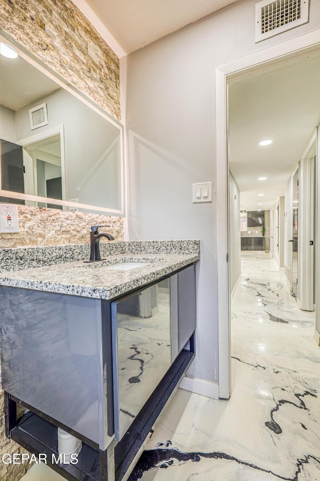 1957 Ratner Cir, El Paso, TX 79936 - bathroom with marble tiled floors, vanity, and baseboards
