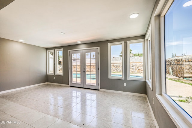 1957 Ratner Cir, El Paso, TX 79936 - empty room featuring plenty of natural light, french doors, baseboards, light tile patterned floors, and recessed lighting