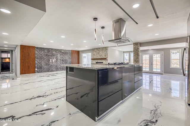 1957 Ratner Cir, El Paso, TX 79936 - kitchen with island range hood, light marble finish flooring, modern cabinets, recessed lighting, and a spacious island