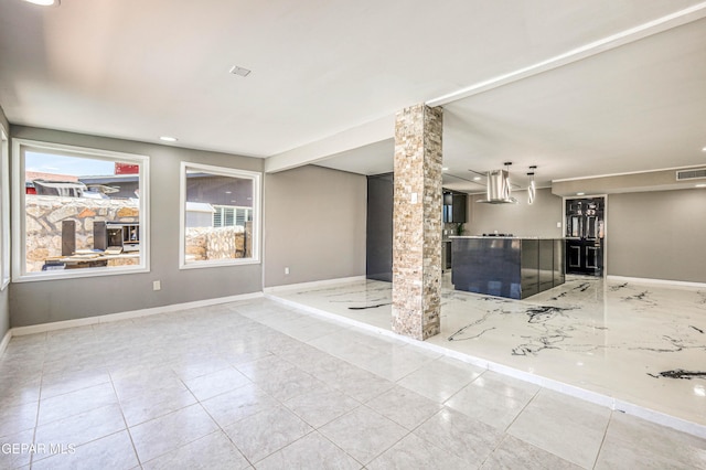1957 Ratner Cir, El Paso, TX 79936 - unfurnished living room featuring baseboards, tile patterned floors, ornate columns, and recessed lighting