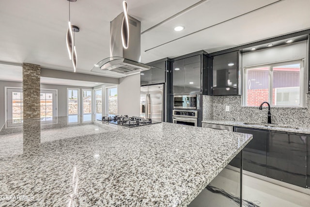1957 Ratner Cir, El Paso, TX 79936 - kitchen with a sink, stainless steel appliances, island exhaust hood, tasteful backsplash, and glass insert cabinets