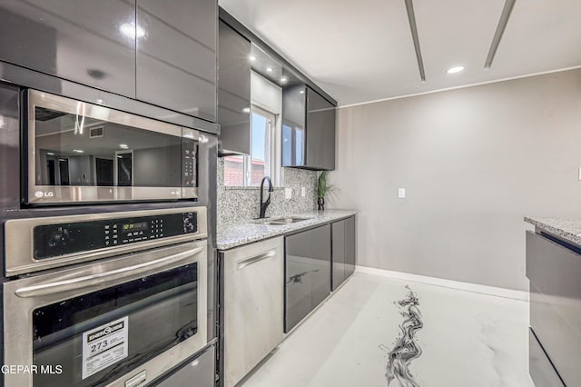 1957 Ratner Cir, El Paso, TX 79936 - kitchen featuring appliances with stainless steel finishes, a sink, modern cabinets, gray cabinets, and light stone countertops