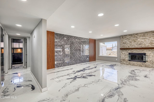 1957 Ratner Cir, El Paso, TX 79936 - unfurnished living room with marble tiled flooring, recessed lighting, a large fireplace, and baseboards