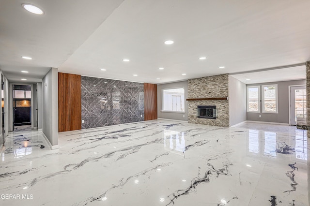 1957 Ratner Cir, El Paso, TX 79936 - unfurnished living room with marble tiled flooring, recessed lighting, a fireplace, and baseboards