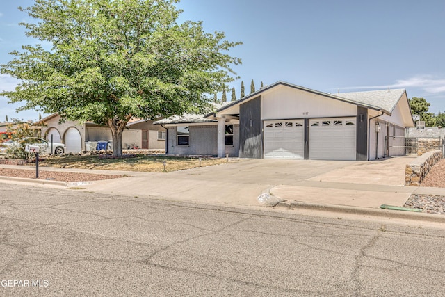 1957 Ratner Cir, El Paso, TX 79936 - view of front of house featuring a garage, driveway, and fence