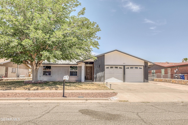 1957 Ratner Cir, El Paso, TX 79936 - view of front of property featuring an attached garage, driveway, fence, and brick siding