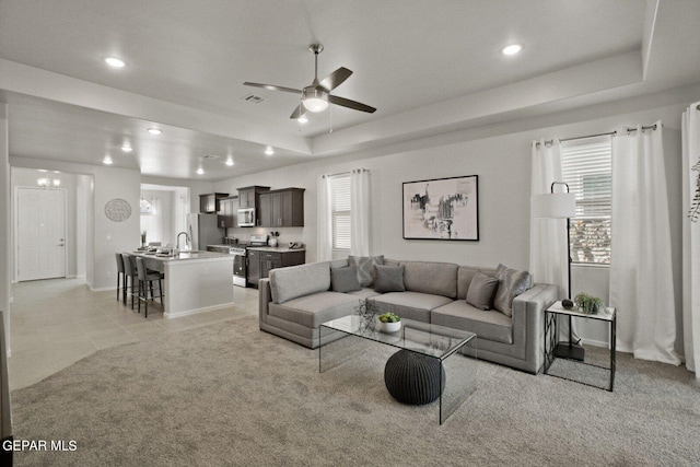 1248 Indigo Sky St, El Paso, TX 79928 - living room featuring a raised ceiling, a ceiling fan, light colored carpet, recessed lighting, and baseboards