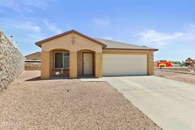 513 Bogota Pl, El Paso, TX 79928 - view of front facade with stucco siding, a garage, and driveway