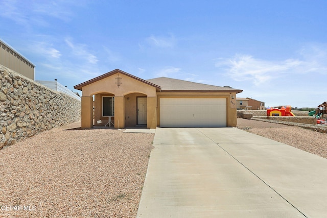 513 Bogota Pl, El Paso, TX 79928 - view of front of property featuring stucco siding, an attached garage, and driveway