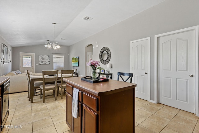 513 Bogota Pl, El Paso, TX 79928 - kitchen with light tile patterned floors, lofted ceiling, open floor plan, a center island, and a chandelier