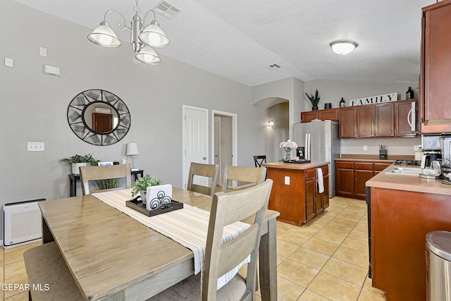 513 Bogota Pl, El Paso, TX 79928 - dining room with arched walkways, vaulted ceiling, a chandelier, and light tile patterned floors