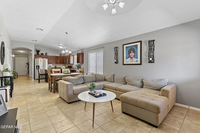 513 Bogota Pl, El Paso, TX 79928 - living room featuring light tile patterned floors, arched walkways, a ceiling fan, vaulted ceiling, and a chandelier