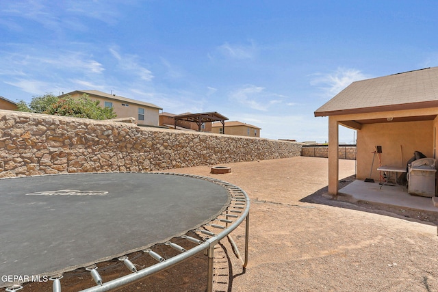 513 Bogota Pl, El Paso, TX 79928 - view of patio / terrace featuring a trampoline and a fenced backyard