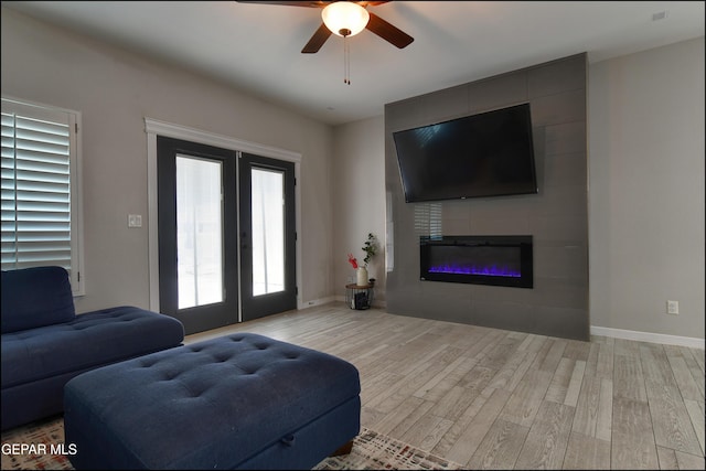 937 Grandevole Dr, El Paso, TX 79932 - living area with wood finished floors, french doors, ceiling fan, baseboards, and a fireplace