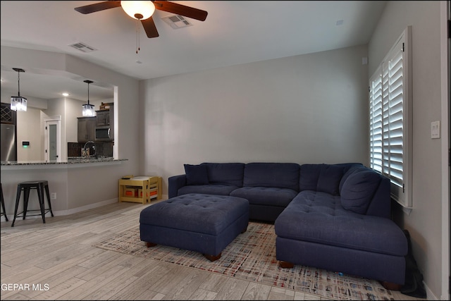937 Grandevole Dr, El Paso, TX 79932 - living room with ceiling fan, light wood finished floors, and baseboards