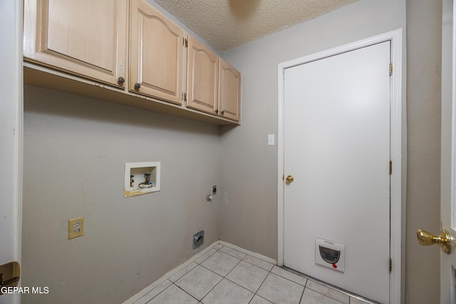 laundry area featuring electric dryer hookup, cabinet space, hookup for a washing machine, light tile patterned flooring, and gas dryer hookup
